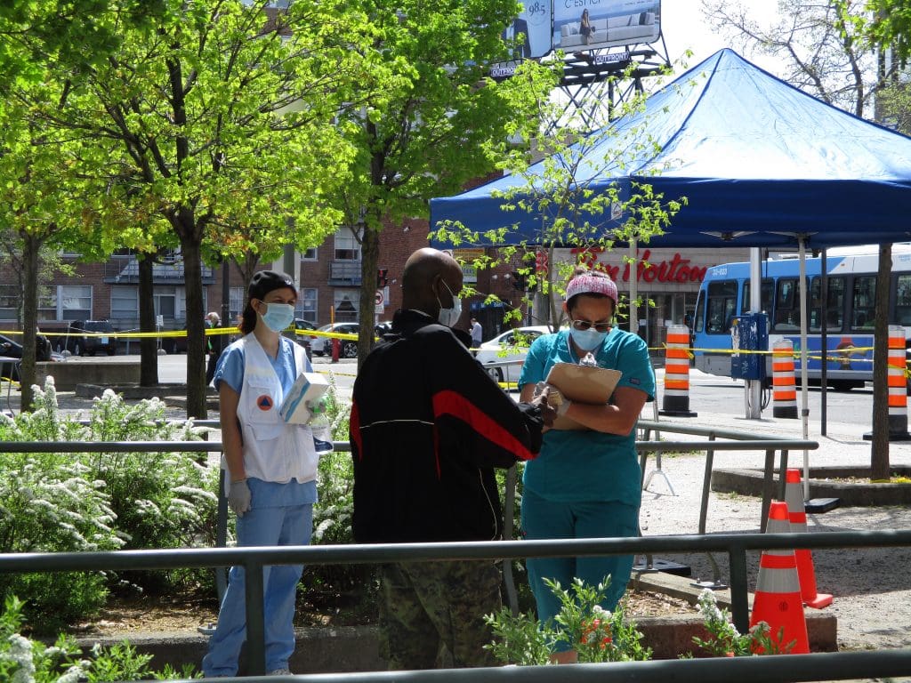 Staff of CIUSSS West Central takes down a resident's contact information outside the mobile COVID-19 testing clinic, set up beside Parc metro station in Montreal's Park Extension borough. testing clinic, covid-19 test, testing for covid